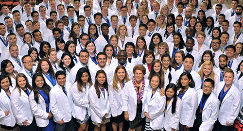 Burrell COM students in their white coats.