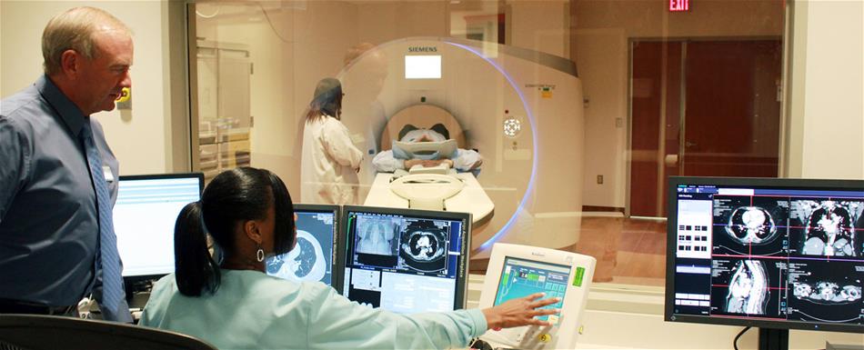 Medical professionals performing a CT scan on a patient. 