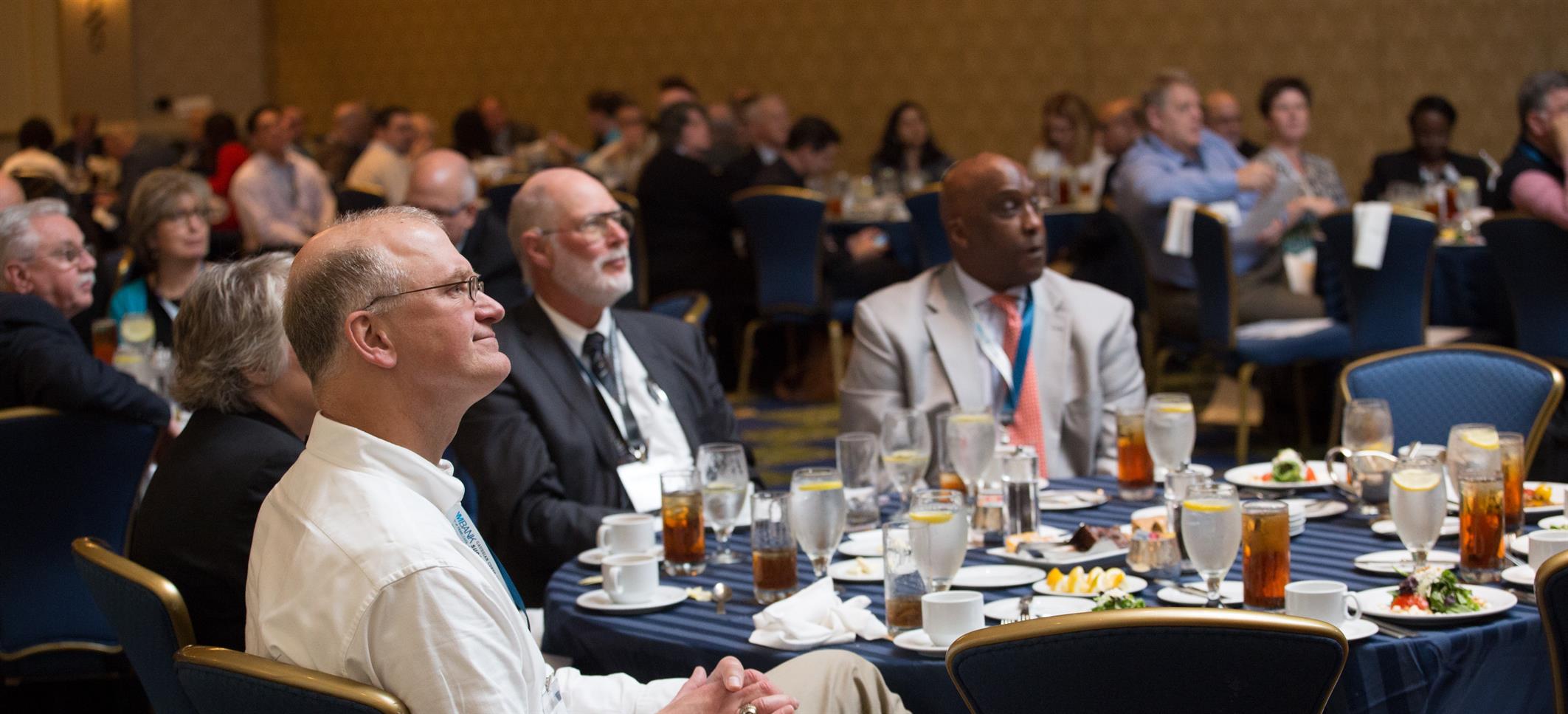 conference attendees listen to a speaker