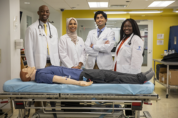 TouroCOM students pose with sim patient