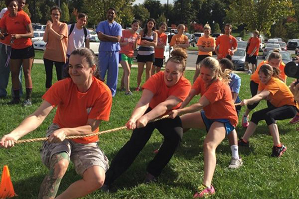 VCOM-Carolinas students playing Tug-of-War outdoors