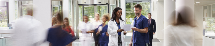 Staff in busy lobby of modern hospital