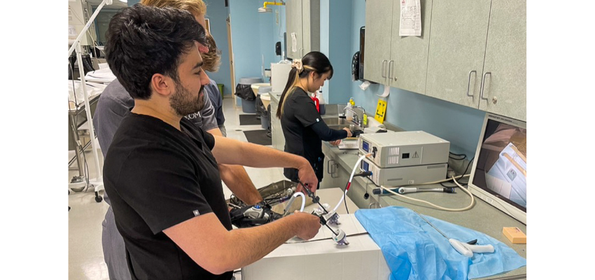 Adrian holds surgical forceps.