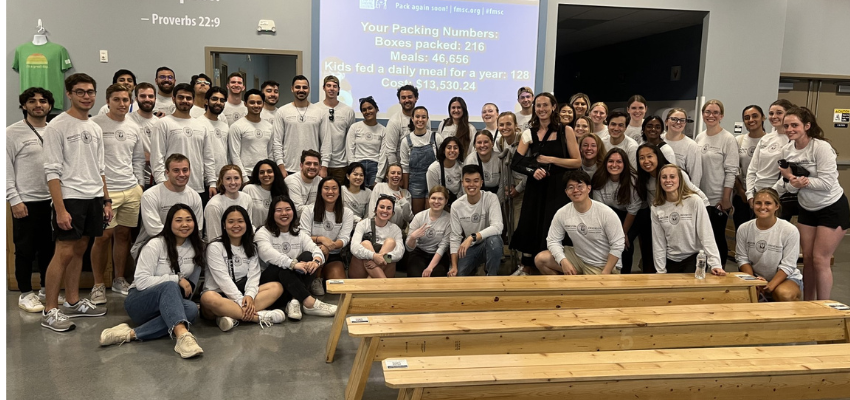 CCOM class posing before packaging meals