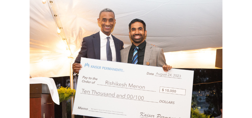 Rishikesh accepting giant check for $10,000