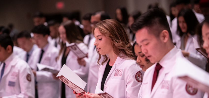 CHSUCOM students read from orientation packets