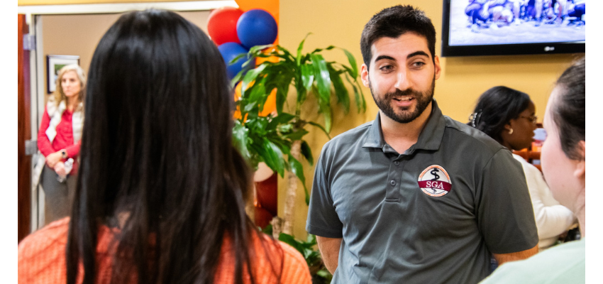 Medical student with SGA shirt welcomes other students