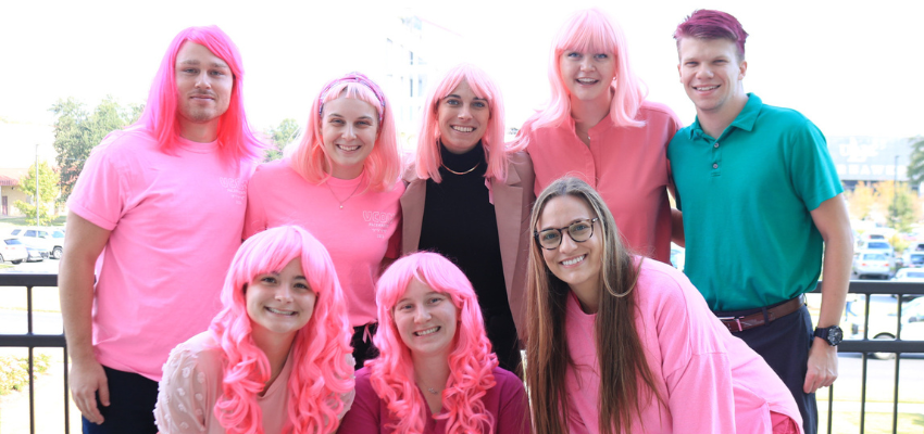Eight students with pink clothes and wigs