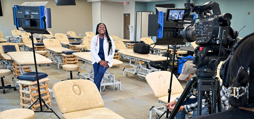 Med student being filmed with studio camera equipment