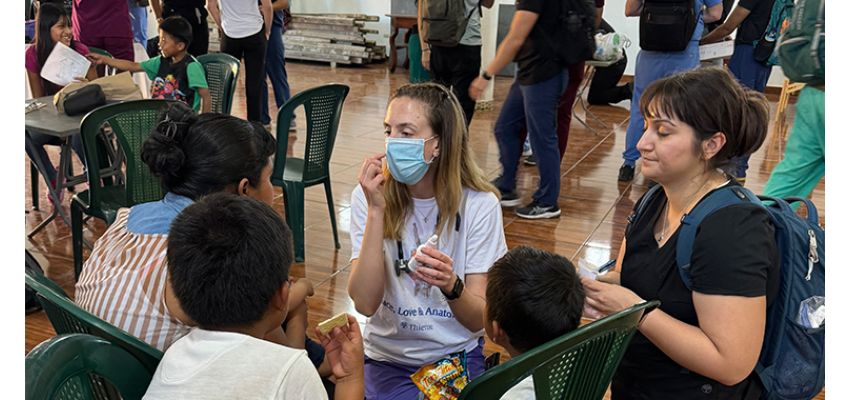 KCU-COM students engage with local children during a community health education event.