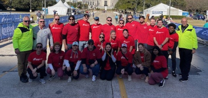 VCOM students pose in front of the marathon path