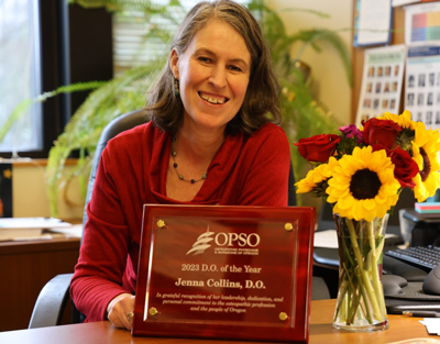 Dr. Jenna Collins poses with her 2023 DO of the Year award.