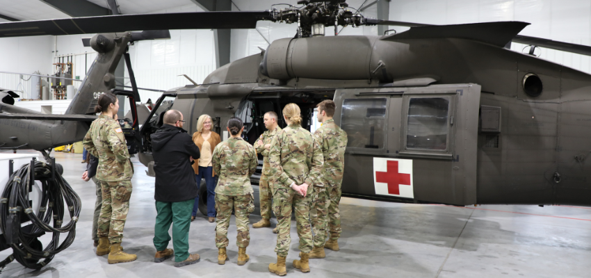 Students standing in front of helicopter