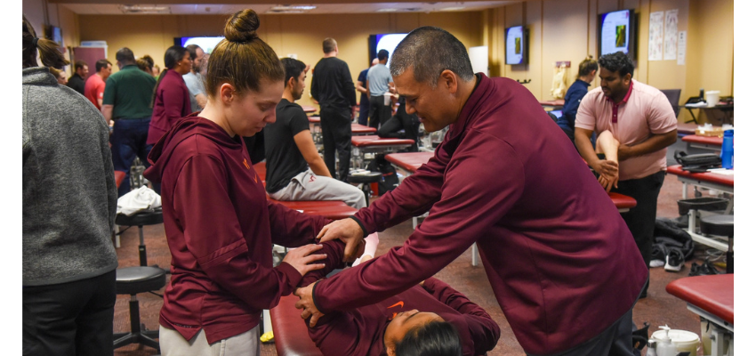 Students practice OMM techniques on each other