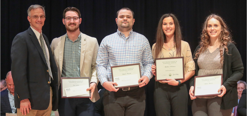 Students standing with certificates