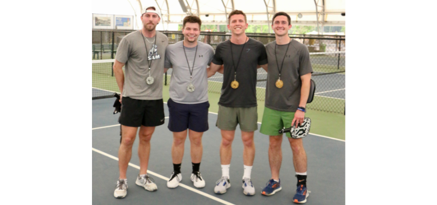 Students smiling on the pickleball court