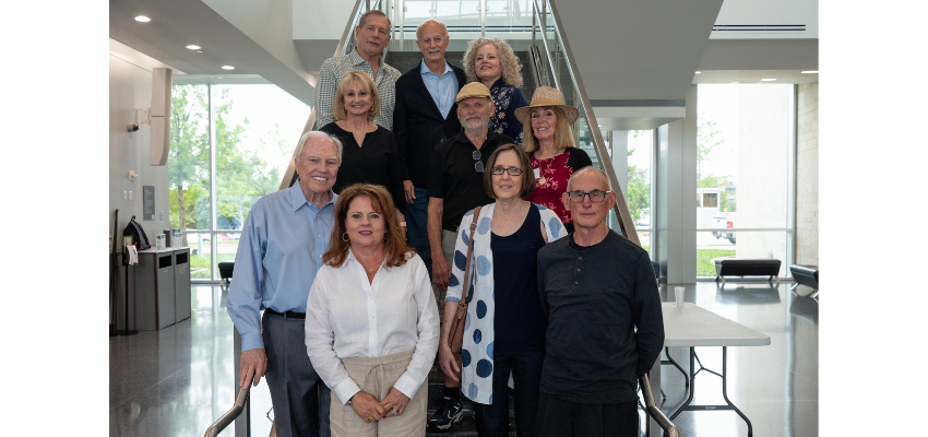 Ten doctors standing on a staircase