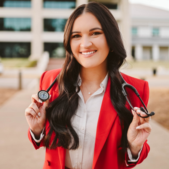 Kylie in a red blazer with a stethoscope