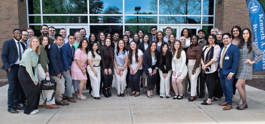 Students pose outside of Kenneth A. Suarez building