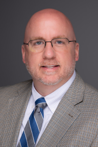 Headshot of a WVSOM faculty member wearing a suit and tie.