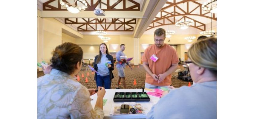 Participants engaging in a workshop activity at a conference venue.