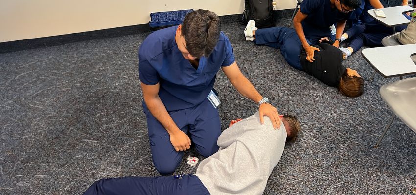 Medical students practice emergency response techniques during a training session.