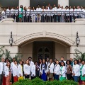 AlargegroupofmedicalstudentsinwhitecoatsgatheroutsideauniversitybuildingforagroupphotoatVCOM-Louisiana